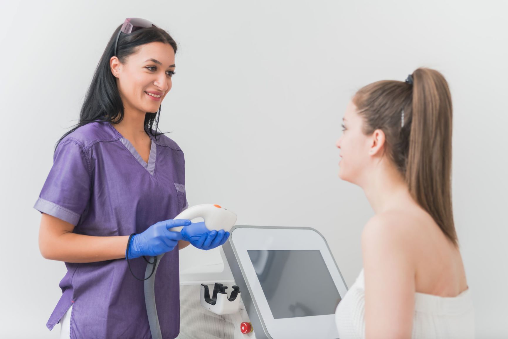 laser hair removal technician performing consultation to assess patient needs